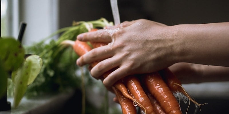 Person washing carrots